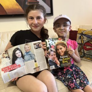 Elana Koenig and her friend Daniz holding copies of People magazine